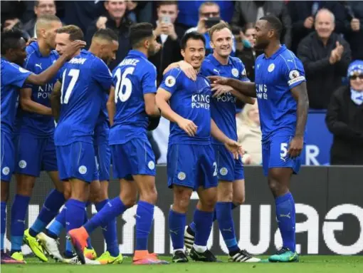  ??  ?? Okazaki is mobbed after grabbing the Foxes' second (Getty)