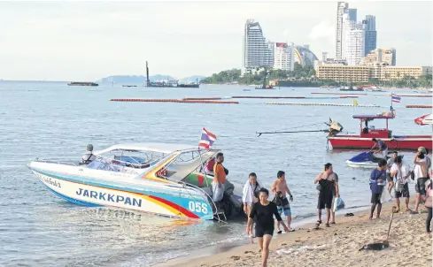  ??  ?? Boats provide rides at Pattaya Beach in Chon Buri province. The city faces a long-term battle in altering its image.