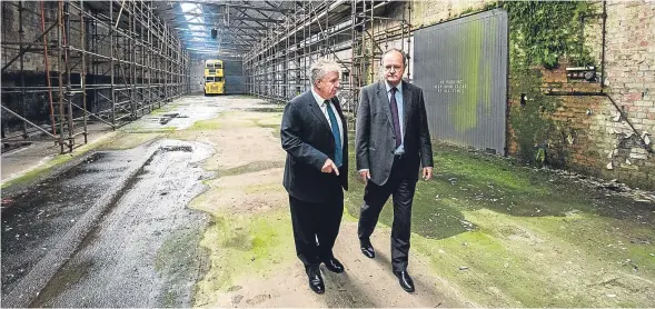  ??  ?? Martin Fairley, of Historic Environmen­t Scotland, guides the museum of transport’s chairman Jimmy McDonell through the depot.