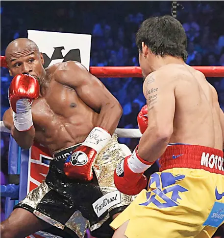  ?? AFP ?? FLOYD Mayweather (left) denies working on a possible rematch with Manny Pacquiao.