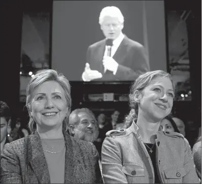  ?? Bloomberg News/STEPHEN HILGER ?? Then-Sen. Hillary Rodham Clinton, D-N.Y., and daughter Chelsea listen in September 2006 in New York as former President Bill Clinton addresses the second Clinton Global Initiative. The annual event has become the public face of the Bill, Hillary and...