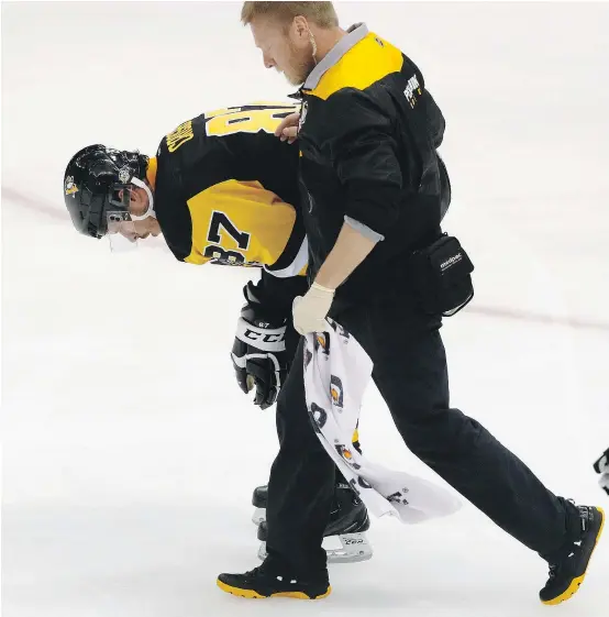  ??  ?? Penguins star Sidney Crosby is helped off the ice after being injured during Game 3 in the team’s playoff series against Washington. Crosby was diagnosed with a concussion and missed Game 4, but returned to play the final three games. — AP FILES