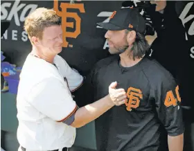  ?? Paul Chinn / The Chronicle ?? An emotional Matt Cain (left) embraces teammate Madison Bumgarner after departing from his final major-league start. Cain threw five shutout innings.