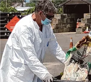  ?? ?? A Clean Harbors employee works a hazardous materials collection point in 2020 in New Haven. Clean Harbors reported a year-over-year increase in toxic materials processed at its main Connecticu­t plant in Bristol, but totals remained well below the levels of 2019 and 2020.