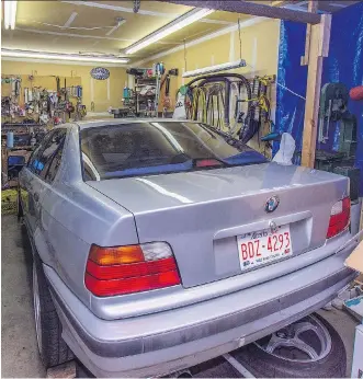  ?? PHOTOS: STANLEY MUNN ?? It’s a humble workspace, but Calgary’s Bruce Borstmayer has rebuilt several vehicles in this bay of the family garage. Borstmayer is a self-proclaimed BMW-rescuer.