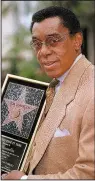  ?? AP ?? Don Cornelius holds a plaque on the Hollywood Walk of Fame in 1997. Cornelius was the executive producer and creator of TV’s Soul Train. The music and dance show is being transforme­d into a Broadway musical.