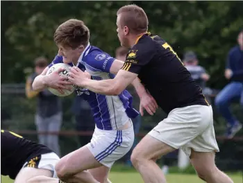  ??  ?? Cathal Devereux of Our Lady’s Island under pressure from Mark Cowman (Adamstown).