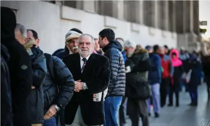  ??  ?? People line up at a bank after the Argentinia­n government imposed currency controls. Photograph: Juan Ignacio Roncoroni/EPA