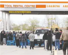  ?? NICK BRANCACCIO ?? Home Depot customers wait in line to enter the Walker Road store Monday as some retailers were permitted to open their doors.