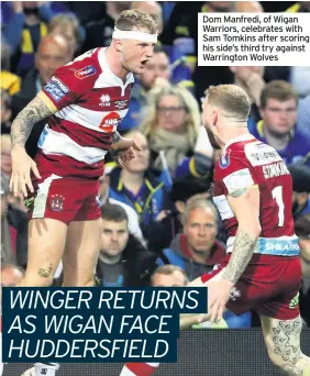  ??  ?? Dom Manfredi, of Wigan Warriors, celebrates with Sam Tomkins after scoring his side’s third try against Warrington Wolves