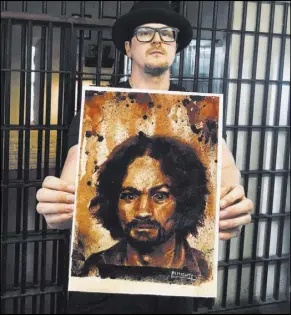  ?? Zak Bagans’ The Haunted Museum ?? Artist Ryan Almighty shows a painting of Charles Manson, with Manson’s ashes used for the eyes.