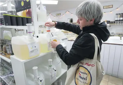 ?? MARIE-FRANCE COALLIER ?? Brigitte Crevier fills her bottle with liquid soap at Épicerie Loco, where customers bring their own bags and containers to shop.