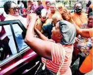  ??  ?? Supporters of the People’s National Party greet South West St Andrew Member of Parliament, Dr Angela Brown Burke, outside of Gordon House yesterday.