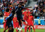  ?? ASSOCIATED PRESS ?? FRANCE’S SAMUEL UMTITI (5) heads the ball to score the opening goal of Tuesday’s match against Belgium in St. Petersburg, Russia.