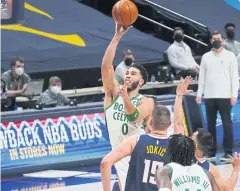  ?? USA TODAY SPORTS ?? The Celtics’ Jayson Tatum, left, goes for a shot against the Nuggets in Denver on Sunday night.
