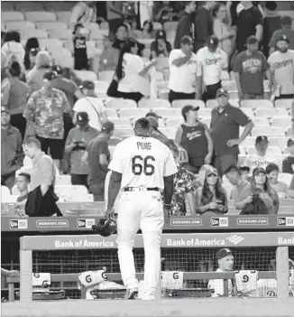  ?? Wally Skalij Los Angeles Times ?? YASIEL PUIG walks off the field after hitting into a game-ending double play, capping a frustratin­g night for the Dodgers offense, which was limited to five hits in the Freeway Series opener.