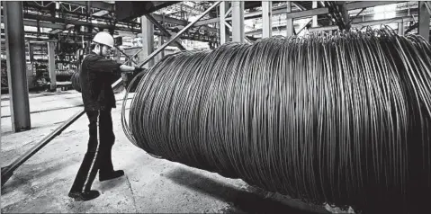  ?? GETTY-AFP ?? A worker handles steel cable Friday at a Chinese factory. China says it’s responding in “equal scale” to U.S. trade action.