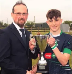  ??  ?? Luke Kavanagh receives the cup from John Harpur.