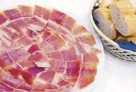  ??  ?? Paper-thin slices of subtle salty, sweet and smoky jamón serrano: Spain’s emblematic contributi­on to world cuisine.