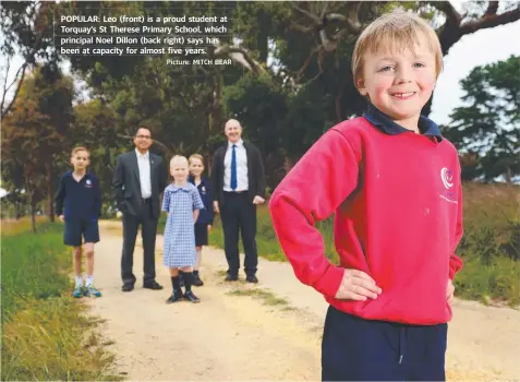  ?? Picture: MITCH BEAR ?? POPULAR: Leo (front) is a proud student at Torquay’s St Therese Primary School, which principal Noel Dillon (back right) says has been at capacity for almost five years.