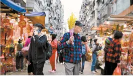  ?? AFP-Yonhap ?? People shop at a market in Hong Kong, Feb. 6. Hong Kong is eager to recover its status as a top tourist destinatio­n.
