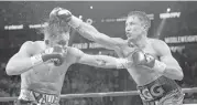  ?? John Locher / Associated Press ?? Gennady Golovkin, right, connects with a right to Canelo Alvarez during their middleweig­ht title fight.