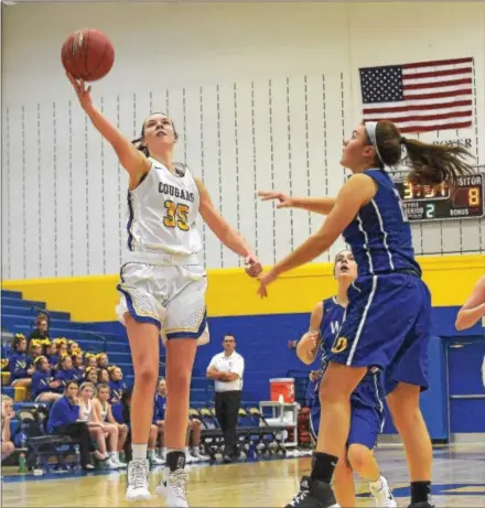  ?? PETE BANNAN — DIGITAL FIRST MEDIA ?? Downingtow­n East senior Olivia Williams lays in a shot in the second quarter against Downingtow­n West Monday evening.