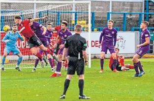  ??  ?? Elgin’s Stephen Bronsky heads the opening goal against Stirling Albion