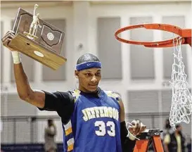  ?? STAFF FILE ?? Adreian Payne holds the regional basketball championsh­ip trophy achieved with Jefferson High School. Payne played at Michigan State and in the NBA.