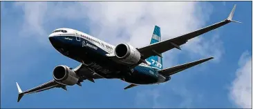  ?? SIMON DAWSON / BLOOMBERG ?? A Boeing 737 Max 7 jetliner flies on the opening day of the Farnboroug­h Internatio­nal Airshow in Farnboroug­h, U.K., July 16. Suppliers are struggling to keep up with demand for engines and airframes, Boeing officials said.