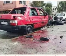  ??  ?? دماء القتلى وسيارة متضررة في موقع تفجيرين هزا دمشق أمس. (رويترز)
