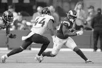  ?? JOHN MCCOY/AP ?? Jaguars linebacker Myles Jack (44) aims to drag down for L.A. Rams running back Sony Michel, who finished with 121 yards on 24 carries on Sunday.