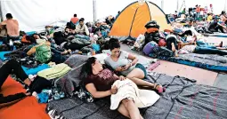  ?? BENEDICTE DESRUS/SIPA USA ?? Central American migrants rest Thursday at a stadium in Mexico City. President Donald Trump on Friday moved to deny asylum to migrants who enter the country illegally.