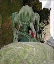  ?? JONATHAN TRESSLER — THE NEWS-HERALD ?? Eastlake Resident John Mark, pictured behind his animatroni­c creature, operates the pneumatic beast Oct. 24 in his Iris Lane driveway. The 13-foot-tall creation is part of the Merk household’s Halloween display this year.