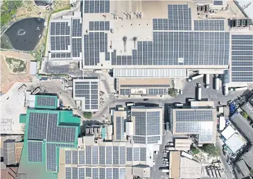  ?? ?? An aerial photograph shows rooftop solar panels installed by New Energy Plus Solutions.