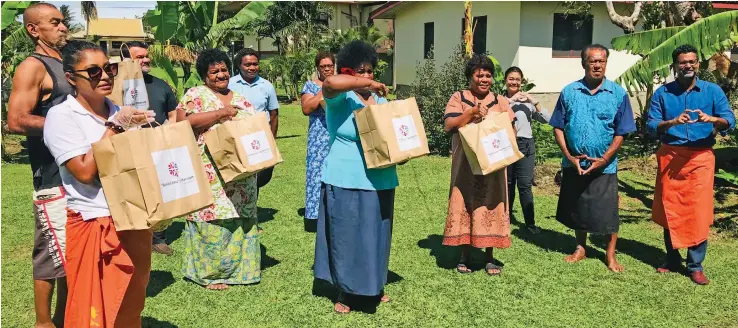  ??  ?? Multi Property Vice President, Fiji & Samoa – Marriott Internatio­nal and General Manager - Sheraton & Westin Resorts, Fiji, Neeraj Chadha, (right) with hotel executives and villagers of Narewa with some food packs on April 30, 2020. Photo:
Charles Chambers