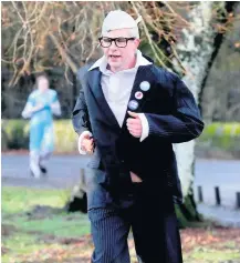  ??  ?? Suited and booted Harriers stalwart Jim Holmes saw the funny side dressed as comedian Harry Hill