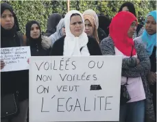  ?? AFP ?? Parents hold signs bearing messages such as ‘veiled or not, we want equality’ as they protest against the Senate bill