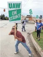  ?? ERIC SEALS/USA TODAY NETWORK ?? Jack Barber, 57, of Clio, Mich., looks to get honks from passing cars as he and other UAW members from Locals 598 and 659 protest in front of the General Motors Flint Assembly plant in Flint, Mich., on Sunday.