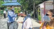  ??  ?? A resident submits to thermal screening at Mandakini Enclave on Sunday. AMAL KS/HT PHOTO