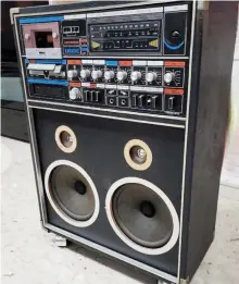  ?? ?? A photo of an early 1980s-era home karaoke system, a simple set with inbuilt speakers and amplifier, and points for the dual microphone­s.