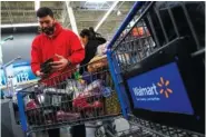  ?? AP PHOTO/EDUARDO MUNOZ ALVAREZ ?? Francisco Santana shops Feb. 9 at the Walmart Supercente­r in North Bergen, N.J. Inflation has led Santana, a New York City resident, to shift from local chains to Walmart.