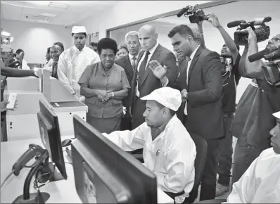  ?? PROVIDED TO CHINA DAILY ?? Staff of an electronic ID-card manufactur­ing unit in Papua New Guinea demonstrat­e the operating system and related technology of Hongda Hi-tech Group Co Ltd.