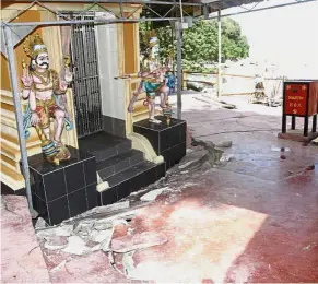  ??  ?? Damaged: Large cracks seen on the floor of the over 100-year-old Sri Aluvang Muneeswara­r Temple in Jalan Batu Ferringhi after the storm.