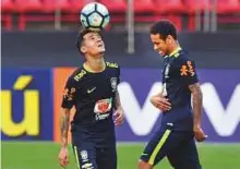  ?? AFP ?? Brazilian players Philippe Coutinho (left) and Neymar take part in a training session at the Morumbi stadium in Sao Paulo ahead of their qualifier against Paraguay.