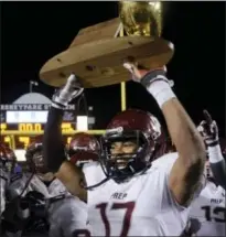  ?? ASSOCIATED PRESS FILE ?? St. Joseph Prep’s Justin Montague holds the championsh­ip trophy after winning the PIAA Class AAAA championsh­ip football game against Pine-Richland in 2014.