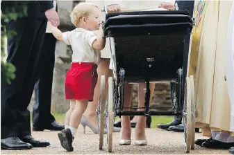  ??  ?? Britain’s Prince George peeks into the stroller of Princess Charlotte flanked by his parents, Prince William and Kate, the Duchess of Cambridge. George will be a page boy at the wedding of his aunt, Pippa.