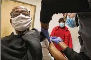  ?? BILL LACKEY / STAFF ?? Former Springfiel­d Police Chief Roger Evans gets a COVID-19 vaccine injection at the Rocking Horse Center.