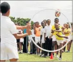  ?? Picture: FREDLIN ADRIAAN ?? PHYSICAL FUN: Lukhanyo Mendu, 11, tosses a rugby ball through a hoop at the Gelvandale track during a day of physical activity for primary school pupils yesterday