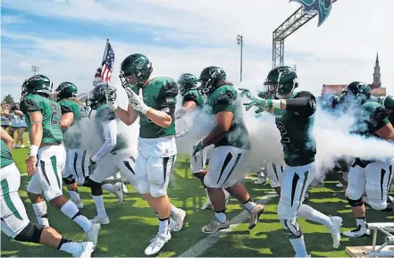  ??  ?? Pictured: The Oklahoma Baptist football team runs out on to the field before a 2017 game. OBU athletic director Robert Davenport says of fall sports, “right now it's 50-50 we push it to spring,” but that is fraught with problems, too. [SARAH PHIPPS/ THE OKLAHOMAN]